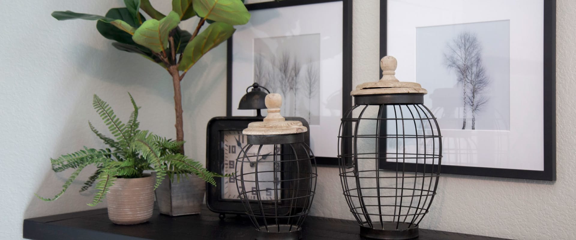 Knick Knacks on top of credenza with plants and wall art